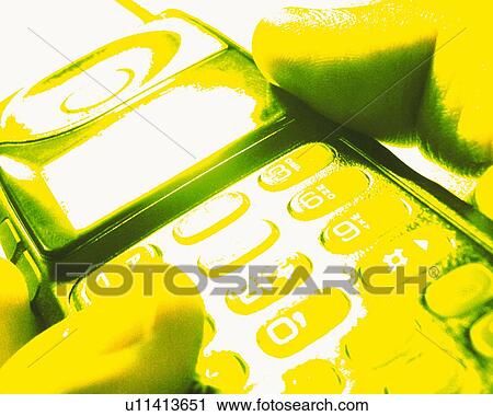 Stock Image - Businessman holding a mobile phone, close up, toned image. Fotosearch