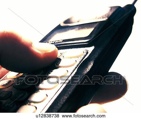 Stock Photo - Businessman holding a mobile phone, close up. Fotosearch