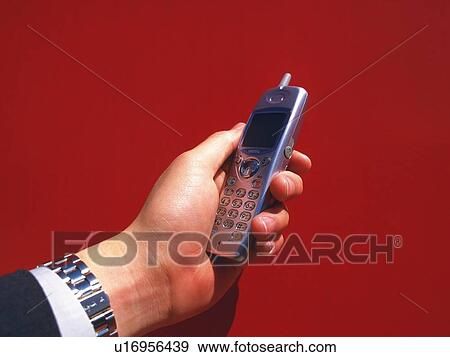 Businessman holding a mobile phone, high angle view View Large Photo Image Stock Photo - Businessman holding a mobile phone, high angle view. Fotosearch