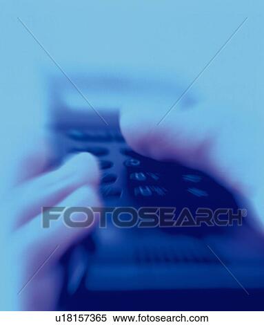 Stock Photography - Businessman holding a mobile phone, close up, low angle view, toned image. Fotosearch