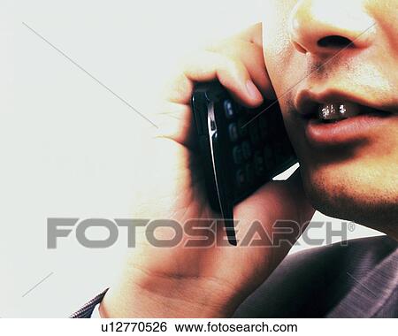 Businessman using a mobile phone, close up View Large Photo Image Stock Photograph - Businessman using a mobile phone, close up. Fotosearch