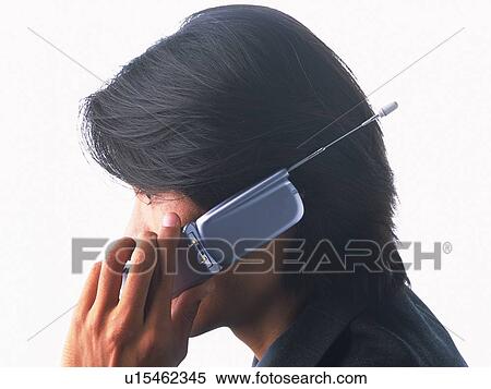 Stock Photography - Businessman using a mobile phone, side view. Fotosearch
