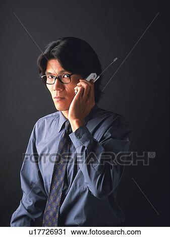 Businessman using a mobile phone, portrait, front view View Large Photo Image Stock Image - Businessman using a mobile phone, portrait, front view. Fotosearch