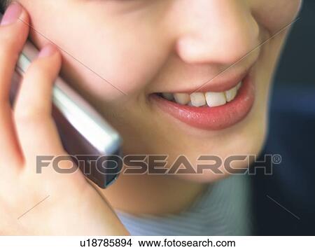 Businesswoman using a mobile phone, smiling, close up, soft focus View Large Photo Image Picture - Businesswoman using a mobile phone, smiling, close up, soft focus. Fotosearch