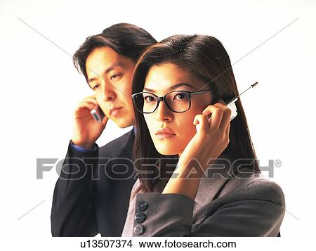 Picture - Man and woman using mobile phone, woman wearing glasses. Fotosearch