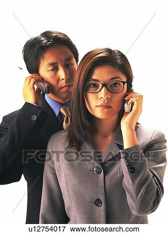 Stock Photo - Man and woman using mobile phone, woman wearing glasses, portrait for woman. Fotosearch