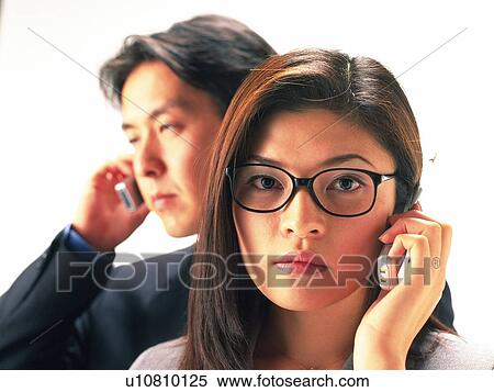 Stock Photography - Man and woman using mobile phone, woman wearing glasses, portrait for woman. Fotosearch