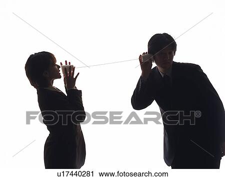 Stock Image - Man and woman using string telephone, side view, front view. Fotosearch