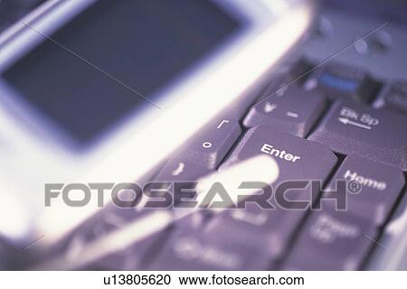 Mobile phone and keyboard of laptop, high angle view, close up View Large Photo Image Stock Image - Mobile phone and keyboard of laptop, high angle view, close up. Fotosearch