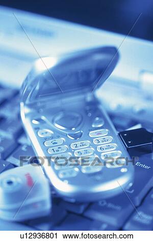 Mobile phone being connected to laptop, high angle view, close up, toned image View Large Photo Image Stock Image - Mobile phone being connected to laptop, high angle view, close up, toned image. Fotosearch