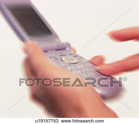Woman holding a mobile phone and pushing buttons, close up, blurred motion View Large Photo Image Stock Image - Woman holding a mobile phone and pushing buttons, close up, blurred motion. Fotosearch