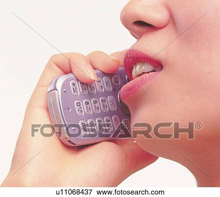Stock Photo - Woman using a mobile phone, low angle view, close up. Fotosearch