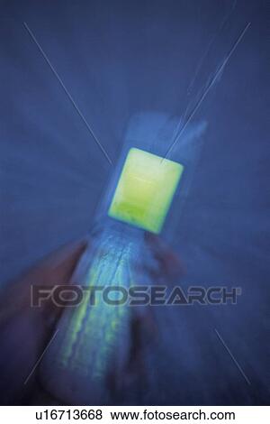 Stock Photo - Holding a Mobile Phone, Blurred Motion, Close Up. Fotosearch