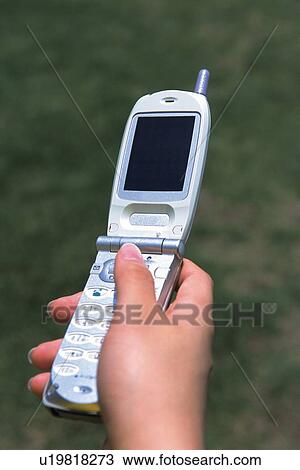 Stock Image - Holding a Mobile Phone, Close Up. Fotosearch