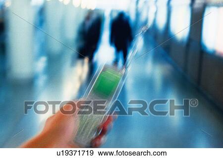 Stock Photo - Holding a Mobile Phone, Front View, Blurred Motion. Fotosearch