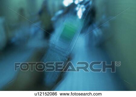 Stock Photograph - Holding a Mobile Phone, Front View, Blurred Motion. Fotosearch