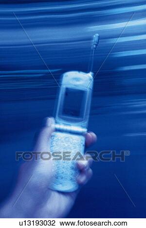 Holding a Mobile Phone, High Angle View, Blurred Motion View Large Photo Image Stock Image - Holding a Mobile Phone, High Angle View, Blurred Motion. Fotosearch