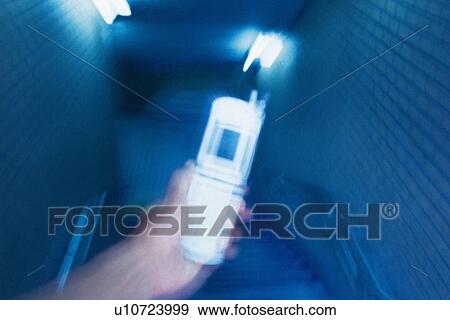 Holding a Mobile Phone, High Angle View, Blurred Motion View Large Photo Image Stock Photo - Holding a Mobile Phone, High Angle View, Blurred Motion. Fotosearch