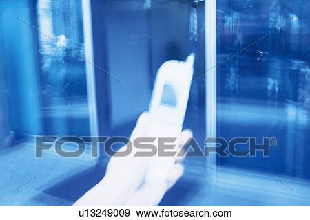 Holding a Mobile Phone, High Angle View, Blurred Motion View Large Photo Image Stock Photo - Holding a Mobile Phone, High Angle View, Blurred Motion. Fotosearch