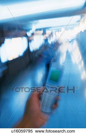 Holding a Mobile Phone, High Angle View, Blurred Motion View Large Photo Image Stock Photography - Holding a Mobile Phone, High Angle View, Blurred Motion. Fotosearch