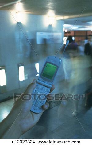 Holding a Mobile Phone, High Angle View View Large Photo Image Picture - Holding a Mobile Phone, High Angle View. Fotosearch