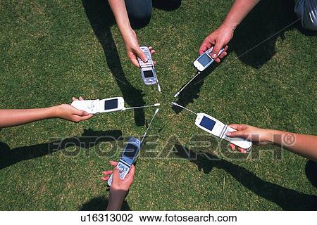 Holding a Mobile Phone, High Angle View View Large Photo Image Stock Image - Holding a Mobile Phone, High Angle View. Fotosearch