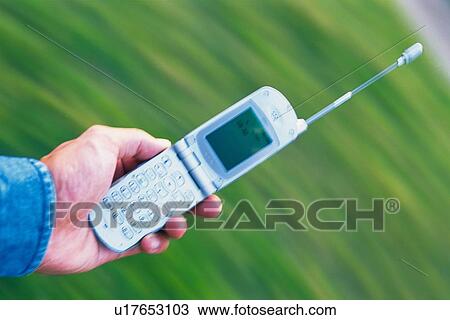 Stock Image - Holding a Mobile Phone, High Angle View. Fotosearch