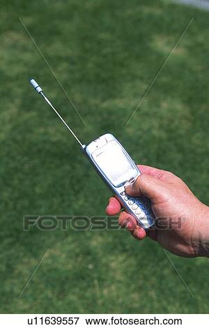 Stock Photo - Holding a Mobile Phone, High Angle View. Fotosearch