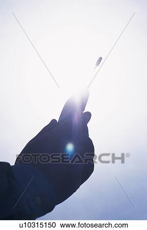 Holding a Mobile Phone, Low Angle View, Silhouette View Large Photo Image Stock Image - Holding a Mobile Phone, Low Angle View, Silhouette. Fotosearch