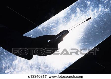 Holding a Mobile Phone, Low Angle View, Silhouette View Large Photo Image Stock Photo - Holding a Mobile Phone, Low Angle View, Silhouette. Fotosearch