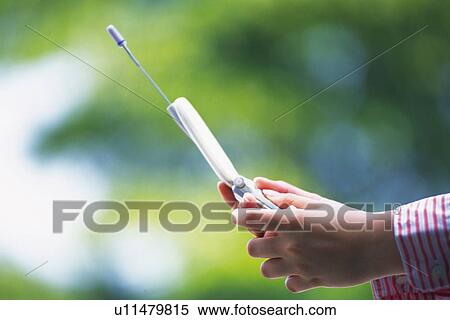Stock Photography - Holding a Mobile Phone, Side View. Fotosearch