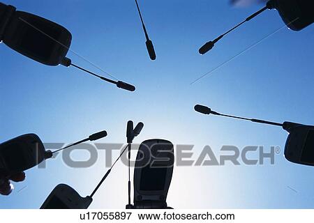 Seven People Holding a Mobile Phone, Low Angle View View Large Photo Image Stock Photo - Seven People Holding a Mobile Phone, Low Angle View. Fotosearch
