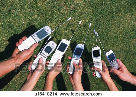 Picture - Six People Holding a Mobile Phone, High Angle View. Fotosearch