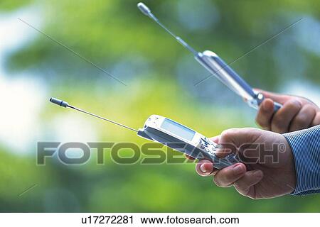 Two People Holding a Mobile Phone, Side View View Large Photo Image Stock Image - Two People Holding a Mobile Phone, Side View. Fotosearch