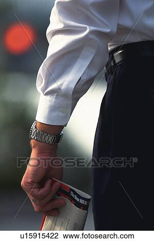 Businessman holding news paper, Rear View View Large Photo Image Stock Image - Businessman holding news paper, Rear View. Fotosearch