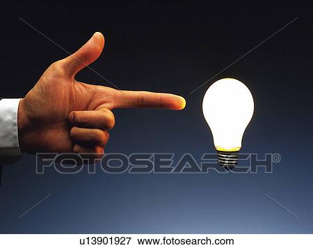 Finger pointing a floating light bulb in the air, Side View View Large Photo Image Stock Photo - Finger pointing a floating light bulb in the air, Side View. Fotosearch
