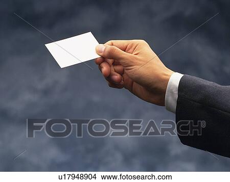 Picture - Hand holding a business card, Side View. Fotosearch