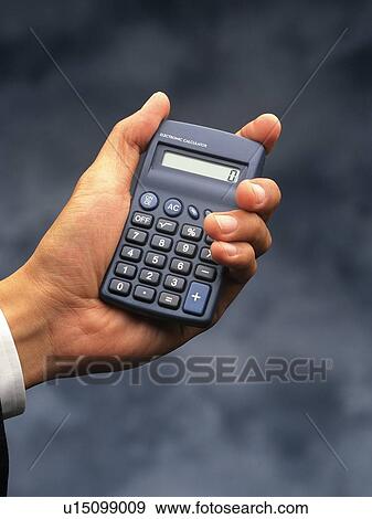Hand holding a calculator, Close Up View Large Photo Image Stock Photo - Hand holding a calculator, Close Up. Fotosearch