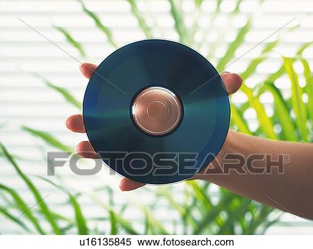 Hand holding a CD, Close Up View Large Photo Image Stock Photography - Hand holding a CD, Close Up. Fotosearch