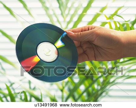 Hand holding a CD, Side View View Large Photo Image Stock Photo - Hand holding a CD, Side View. Fotosearch