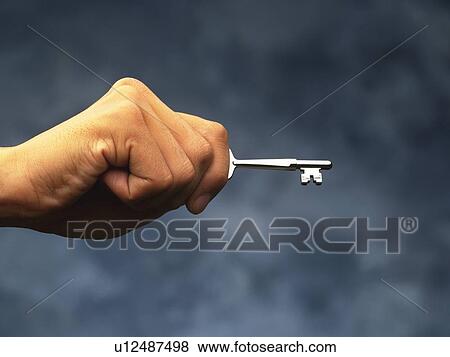 Hand holding a key, Side View View Large Photo Image Stock Photo - Hand holding a key, Side View. Fotosearch