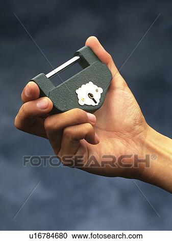Hand holding a padlock, Close Up View Large Photo Image Stock Image - Hand holding a padlock, Close Up. Fotosearch
