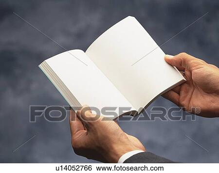 Stock Photograph - Hands holding a book, High Angle View. Fotosearch