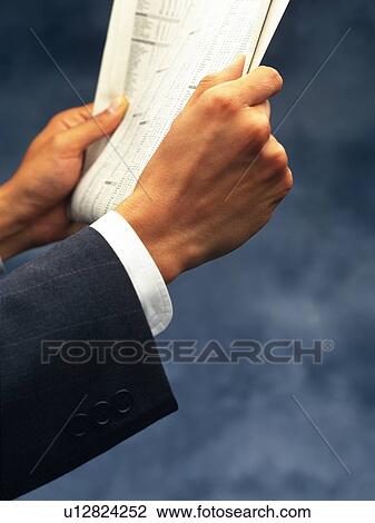 Stock Image - Hands holding News Paper, Close Up. Fotosearch
