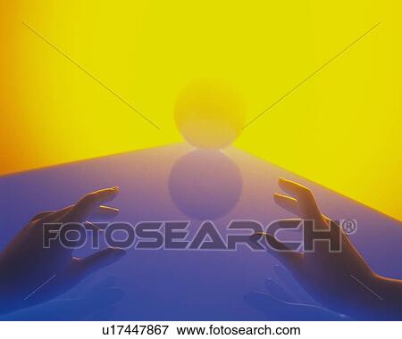 Stock Photo - Hands reaching a ball, Low Angle View. Fotosearch