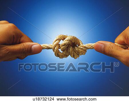 Hands tying a rope, Close Up View Large Photo Image Picture - Hands tying a rope, Close Up. Fotosearch