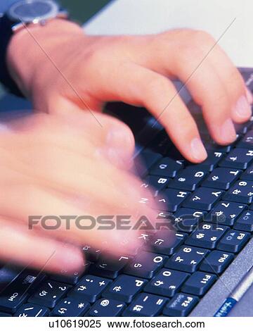 Stock Photography - Hnds typing keyboard, High Angle View, Blurred Motion . Fotosearch