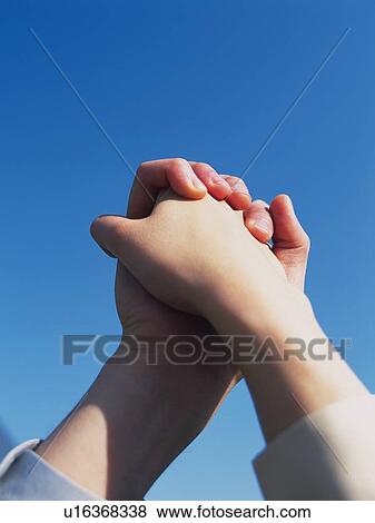 Two hands crossing fingers, Low Angle View, Close Up View Large Photo Image Stock Photo - Two hands crossing fingers, Low Angle View, Close Up. Fotosearch