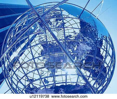 Stock Photo - Big globe in front of high-rise building, low angle view, close up, toned image. Fotosearch