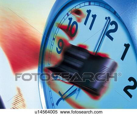 Stock Photography - Businessman using mobile phone and image of clock, CG, composition, low angle view, close up. Fotosearch
